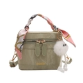 Olive green vintage bucket bag with silk scarf handle and plush ball charm in front view - Basic Style / Green