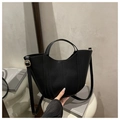 Detail of minimalist black bucket bag featuring vertical stitching and golden hardware strap - Black