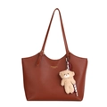 Brown leather tote bag with shoulder strap and plush bear charm on white background - With Ornament / Brown