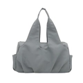 Minimalist grey nylon tote bag with wide integrated handles and side pockets on white back - Blue