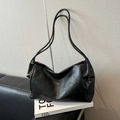 Minimalist black soft PU leather tote bag with embossed letters on a vintage sofa - Black without Pendant