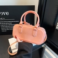 Glossy coral pink Boston bag with golden hardware and adjustable crossbody strap - Pink