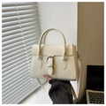 Detail of cream leather crossbody bag featuring silver buckle and elegant top handle - White
