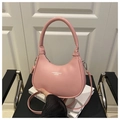 Detail of light pink crescent hobo bag with top handle and matching adjustable shoulder strap - Pink