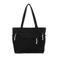 Large black nylon tote bag with white rope zipper pulls and front pocket on white background - Black