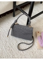 Detail of grey leopard print handbag featuring velvet texture and gold metal ring hardware - Gray