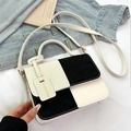 Minimalist black and white contrast leather handbag with adjustable strap and tag - Black