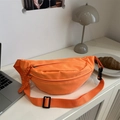 Bright orange crossbody chest bag with adjustable strap in a casual lifestyle setting - Orange