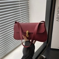 Elegant wine red leather shoulder bag with gold cylindrical lock and textured finish - Red