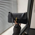 Classic black pebbled leather handbag with gold metal lock and shoulder strap detail - Black