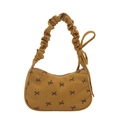 Mustard yellow corduroy shoulder bag featuring black bow prints and pleated strap details - Yellow