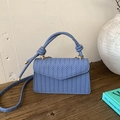 Blue woven faux leather shoulder bag with V-shaped flap and decorative knot handle - Blue