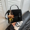 Fashionable black faux leather backpack with subtle leopard print and cute bear charm - Black with Charm