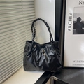 Minimalist black tote bag with wavy pleats and braided shoulder strap on a windowsill - Diagonal Pleated (6774) / No Pendant / Black