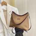 Minimalist canvas bucket bag with brown leather trim shown in a stylish lifestyle setting - Brown Large No Pendant