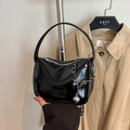 Glossy black patent leather handbag with silver chain and fashion embossed label - Black