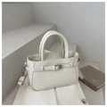 Close-up of a cream bucket bag with leather texture, buckle detail, and silver zipper on steps - White