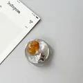 Detail of silver foil phone grip with amber resin, faux pearl, and star ornament - Silver Foil Style 12