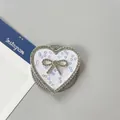 Vista de cerca del soporte de móvil corazón plateado con lazo de diamantes y lentejuelas - Corazón Lazo Magnético Diamantes-Lentejuelas / Blanco