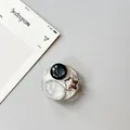 Detail view of round silver phone grip with star accent and marble texture inlay - Silver Foil Style 6
