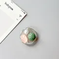 Detail of round phone grip with faux pearl, pink gemstone, and green stone inlay - Silver Foil Style 7