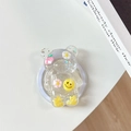 Detail view of glitter-filled resin bear phone grip with dried flowers and strawberry - Magnetic - Bear - Sequins Daisy Strawberry Smile - Yellow