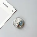 Close-up of heart gemstone and silver foil texture on a round phone grip stand - Silver Foil Style 9
