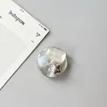 Close-up of a circular phone socket featuring faux jewels and a polished silver star charm - Silver Foil Style 11