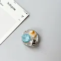 Detail of round phone socket with blue gemstone, marble square and silver star charms - Silver Foil Style 13