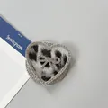 Detalle macro del soporte para móvil de corazón con leopardo y pedrería brillante - Corazón Lazo Magnético Diamantes-Leopardo Grande / Gris