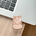 Detail of pink translucent bear phone grip with pearlescent glitter on a laptop surface - Adhesive Pop Grip Glitter Bear-Orange