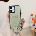 Detail of mint green leather iPhone case with rhinestone logo and heart bead chain - Pearlescent Rhinestone Letter M Star Chain Style / Green / iPhone 17 Pro Max