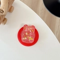 Detailansicht der rosa Glitzer-Bär Handyhalterung mit Goldsternen und Harz-Oberfläche - Magnetisches Modell / Rot