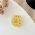 Makroaufnahme von Bären-Handyhalterung mit goldenem Glitzer und Stern-Pailletten - Magnetisches Modell / Gelb