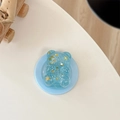 Detail of blue glitter bear phone stand with star sequins on a white background - Magnetic Model / Blue