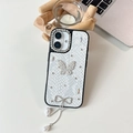 Detail of luxury white faux-leather iPhone case with rhinestone butterfly and pearl tassels - White / 16e