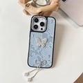 Detail of light blue lace iPhone case with rhinestone butterfly and pearl tassel - Blue / 16e