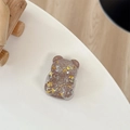 Detailed view of a brown glitter bear phone stand with sparkling gold star sequins - Telescopic Stand Style / Brown