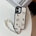 Detail of cream leather iPhone case featuring silver butterflies and pearl lanyard - White / iPhone 17 Pro Max