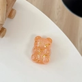 Close-up of glitter bear phone grip with golden stars and orange sequins on white desk - Telescopic Stand Style / Orange