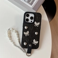 Detail of iPhone case with black wrinkled leather, silver butterflies and pearl strap - Black / iPhone 17 Pro Max