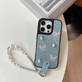 Detail of light blue wrinkled leather iPhone case with crystal butterflies and pearl strap - Blue / iPhone 17 Pro Max