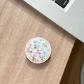 Macro detail of round phone socket with colorful heart sequins on wooden desk - Colorful Sequins No.1