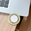 Close-up of a circular MagSafe phone socket grip with Gift For You text on wooden desk - Light Green