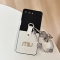 Detail of leather folding case with rhinestone letters and decorative beaded charm strap - White / Samsung ZFlip3