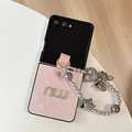 Detail of pink pleated leather case with gold lettering and beaded charm for Z Flip - Pink / Samsung ZFlip3