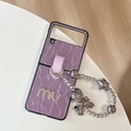 Macro shot of purple pleated leather phone case with metallic charms for Z Flip 6 - Purple / Samsung ZFlip3