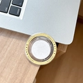 Macro detail of MagSafe phone grip with Gift For You print on minimalist desk setup - Yellow