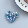 Macro view of blue glitter heart phone socket with sparkling sequins and holographic finish - Adhesive Heart Stand - Light Chasing Blue