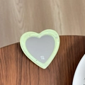 Detail of a heart-shaped glitter mirror phone stand with mine text on a wooden surface - Light Green